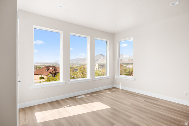 1510 West 600 North, Unit GE 04 Mapleton, UT 84664 - Photo 9 of 21 Spacious room featuring multiple large windows, wood-finish flooring, recessed lighting, and white baseboards