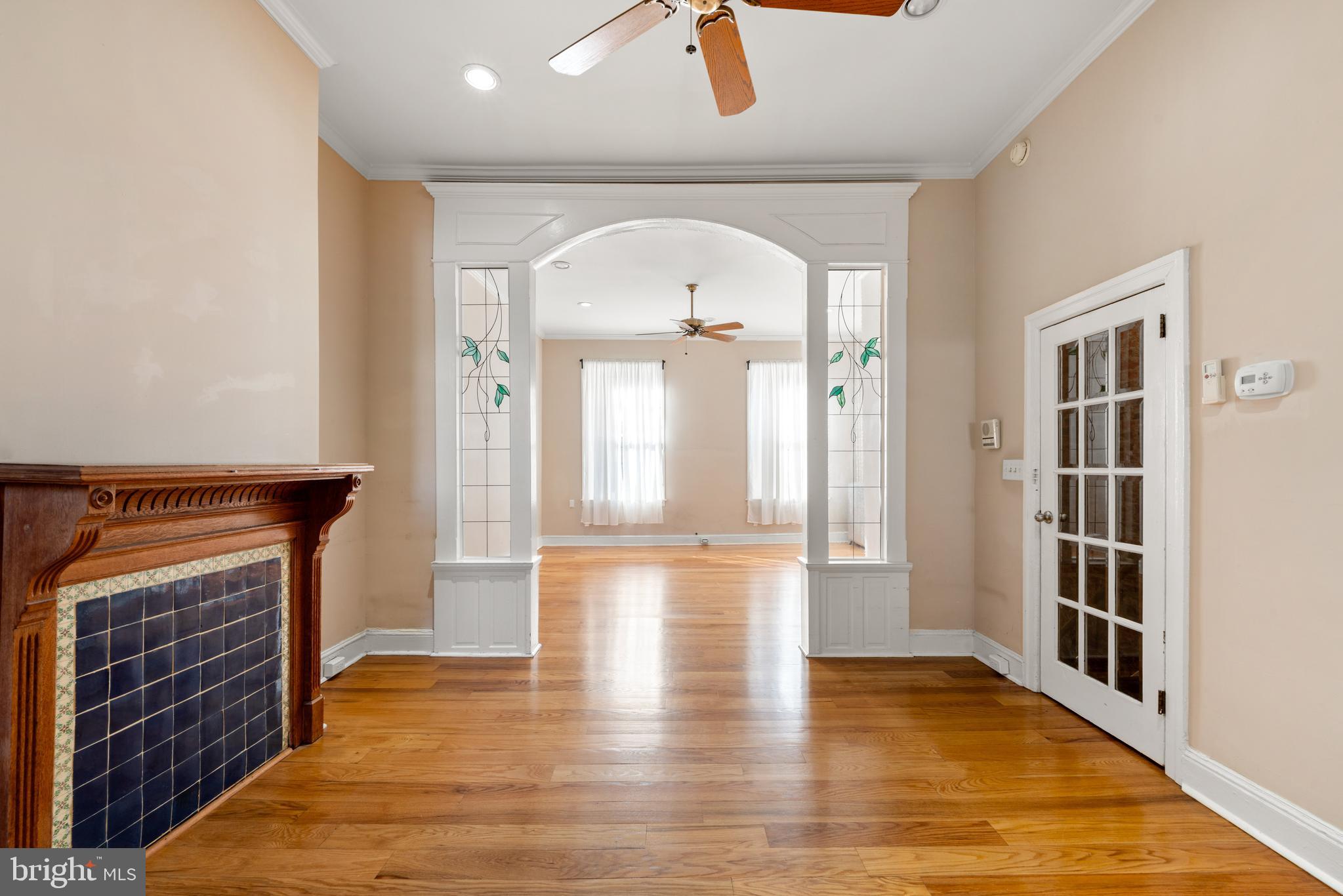 713 South 4th Street Philadelphia, PA 19147 - Photo 45 of 85 wooden floor in an empty room with a fireplace and a window