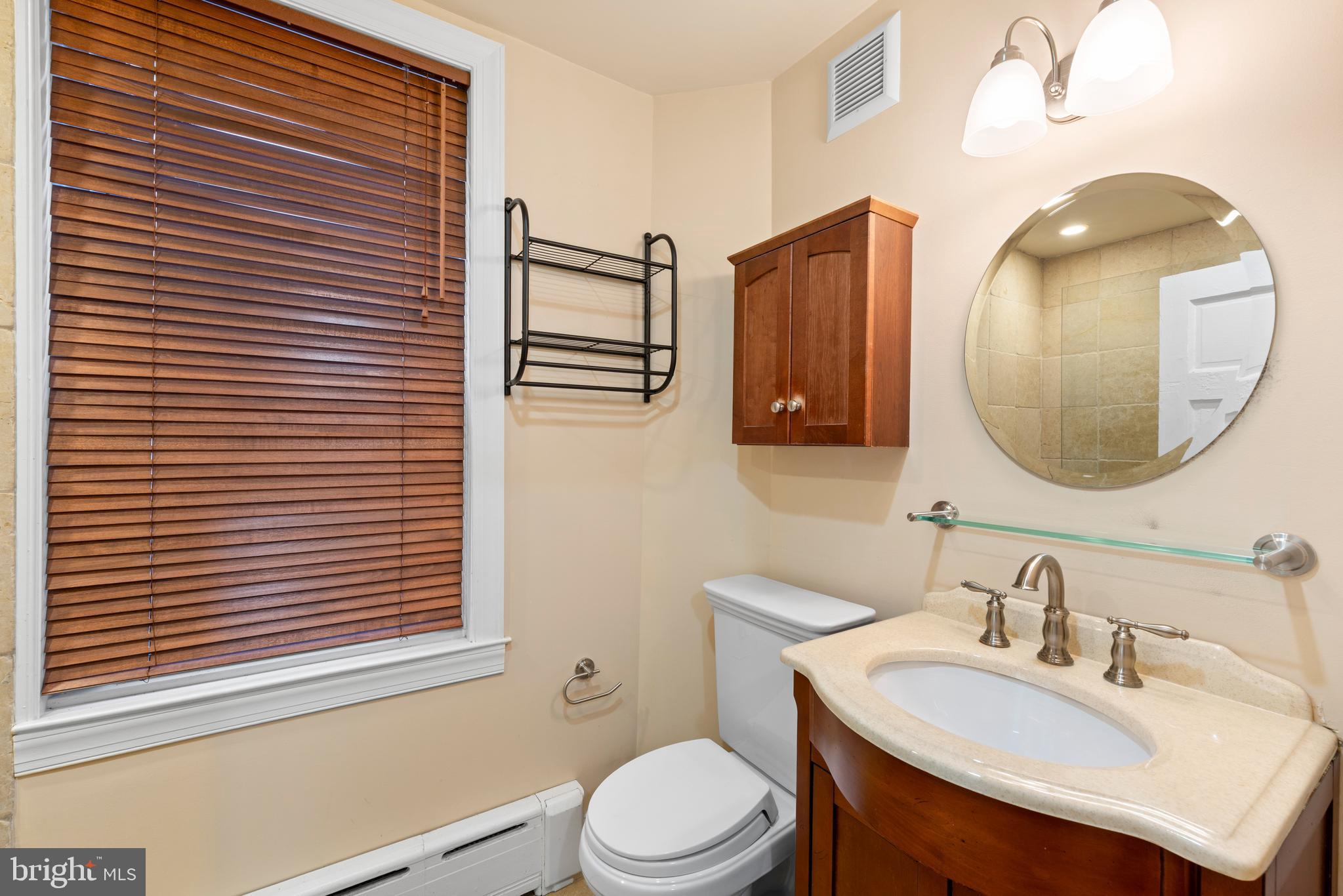 713 South 4th Street Philadelphia, PA 19147 - Photo 57 of 85 a bathroom with a toilet a sink and mirror