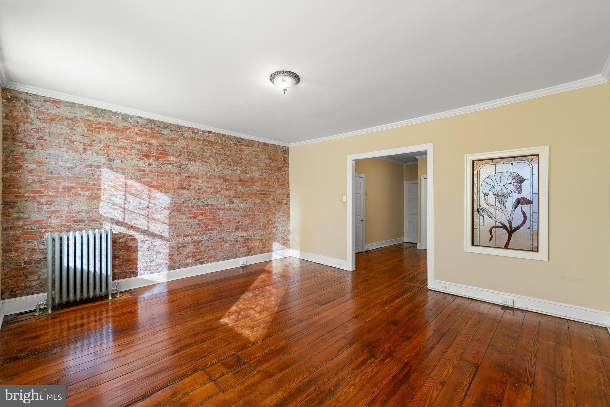 713 South 4th Street Philadelphia, PA 19147 - Photo 64 of 85 a view of an empty room with wooden floor and wall painting