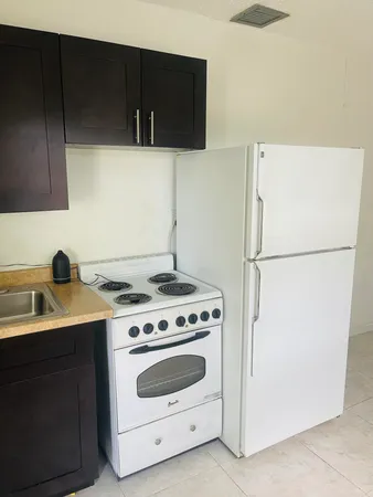 a kitchen with a stove and a refrigerator
