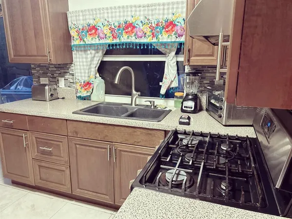 a kitchen with a sink stove and cabinets
