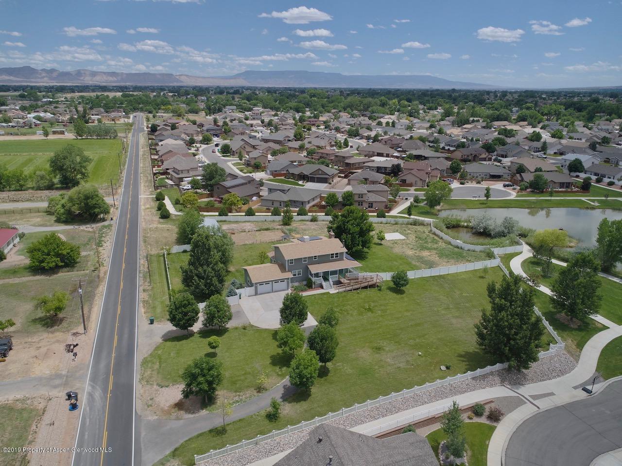 1763 K 6/10 Road Fruita, CO 81521 - Photo 5 of 29 an aerial view of a house with a garden and lake view
