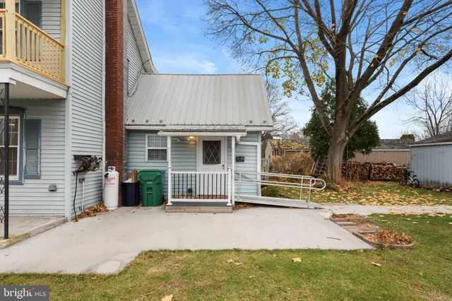 a kitchen with cabinets and chairs