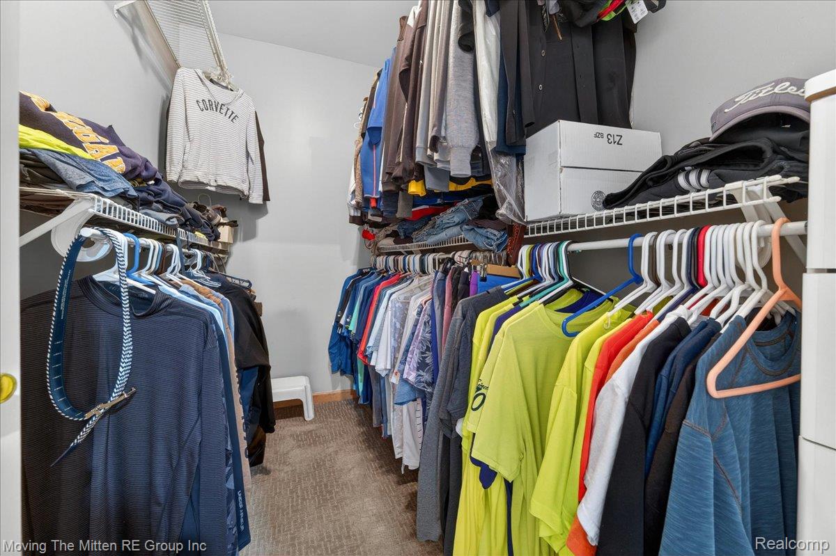 39750 Willow Road New Boston, MI 48164 - Photo 30 of 68 Spacious walk-in closet featuring light grey walls, built-in wire shelving, hanging rods, and carpeting