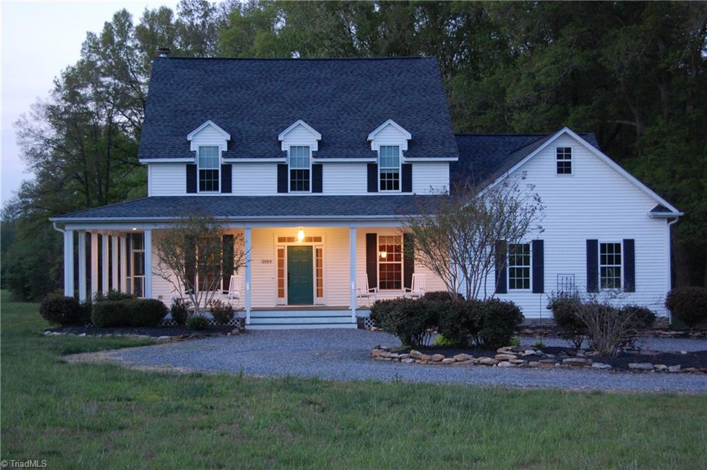 1484 Smothers Road Madison, NC 27025 - Photo 1 of 30 Enjoy the evening on the rocking chair porch.