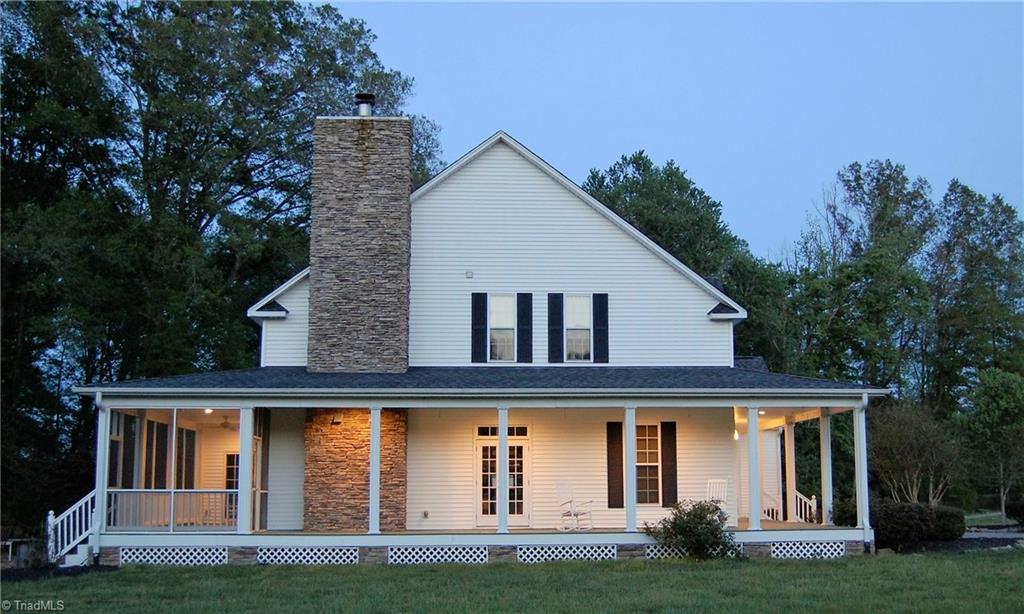 1484 Smothers Road Madison, NC 27025 - Photo 2 of 30 Wraparound porch with rear screen porch, stone chimney, and patio.