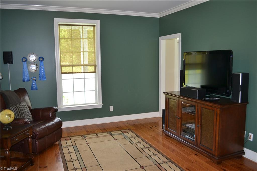 1484 Smothers Road Madison, NC 27025 - Photo 12 of 30 Living room with access to the side door and computer/work area. The work area has been pre-plumbed to function as a wet bar!!