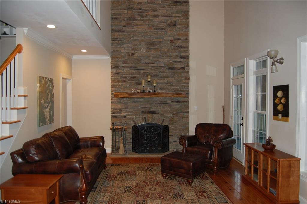 1484 Smothers Road Madison, NC 27025 - Photo 13 of 30 Family room. This room features a gas log fire place with wonderful wood mantel and two stories of stonework. There are two entrances to the large screen porch.