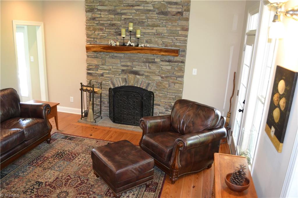 1484 Smothers Road Madison, NC 27025 - Photo 14 of 30 Living room with gas log fireplace and two story accent stonework.