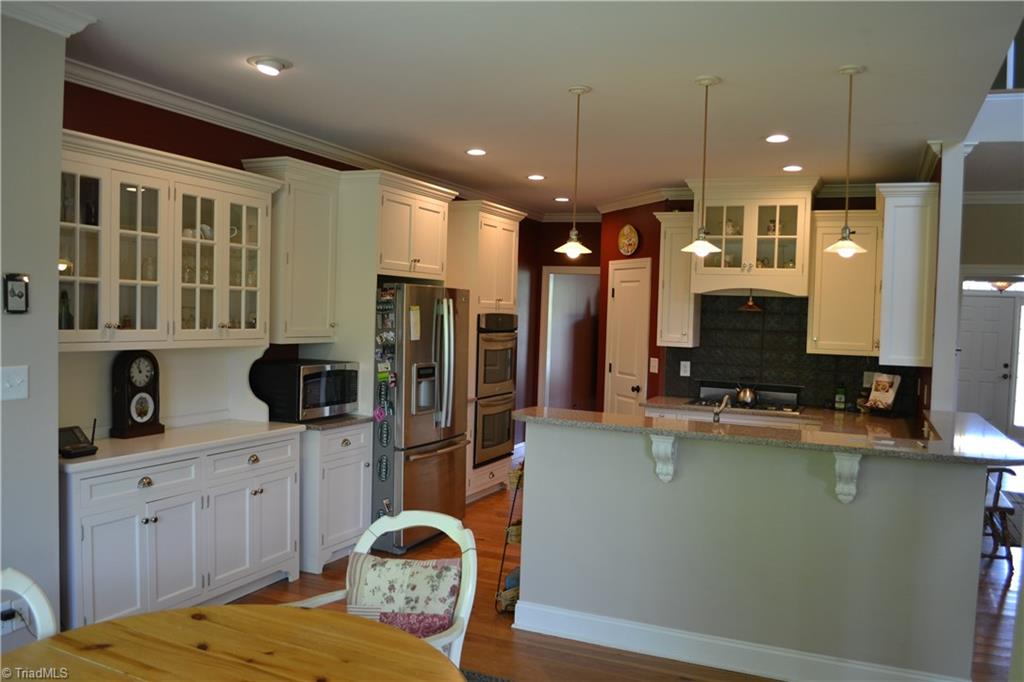 1484 Smothers Road Madison, NC 27025 - Photo 17 of 30 The kitchen as seen from the large eat in breakfast nook. the side board on the left will be conveyed with the home.