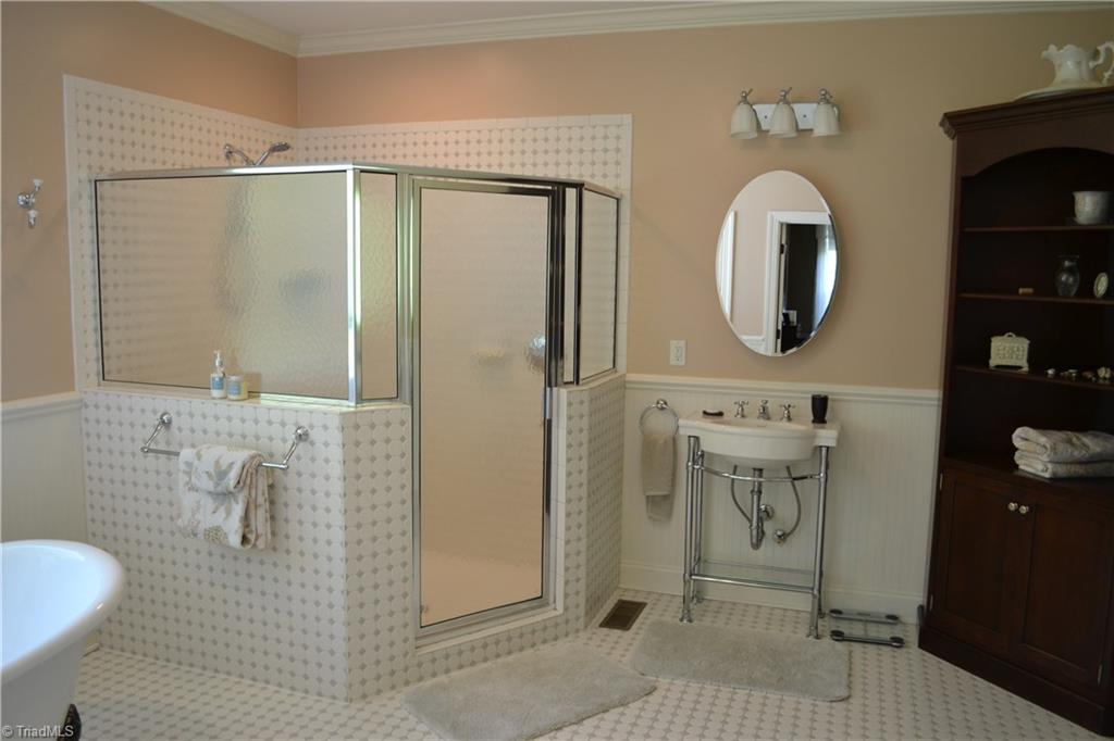1484 Smothers Road Madison, NC 27025 - Photo 22 of 30 Never feel cramped again thanks to this oversized shower. One of the two his and hers sinks are also shown.