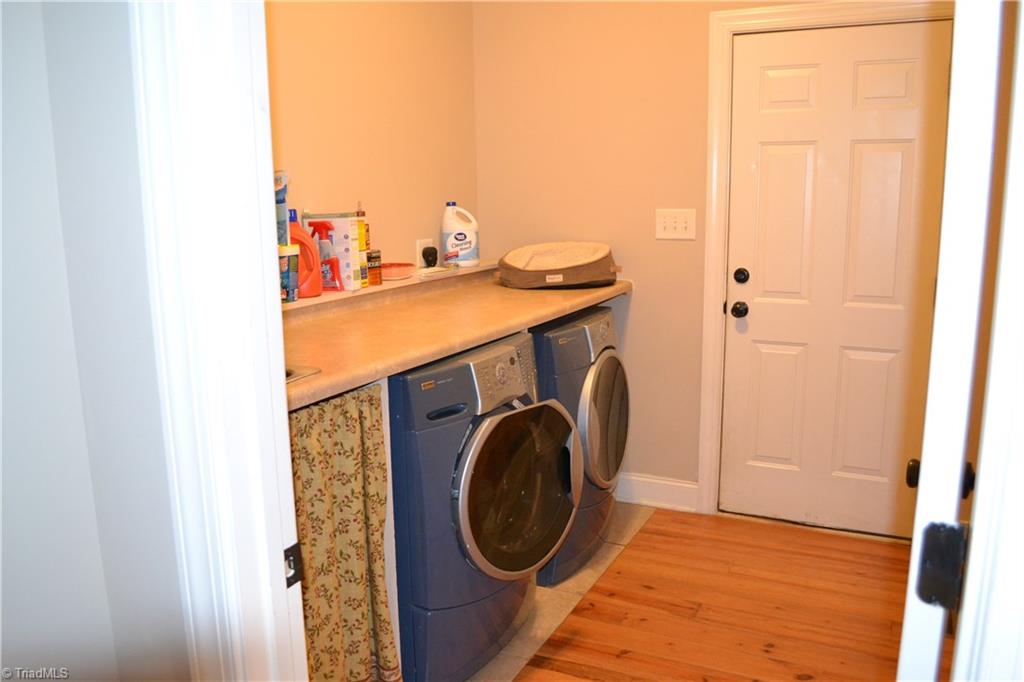 1484 Smothers Road Madison, NC 27025 - Photo 24 of 30 Main floor laundry with large wash sink and entry into the garage.
