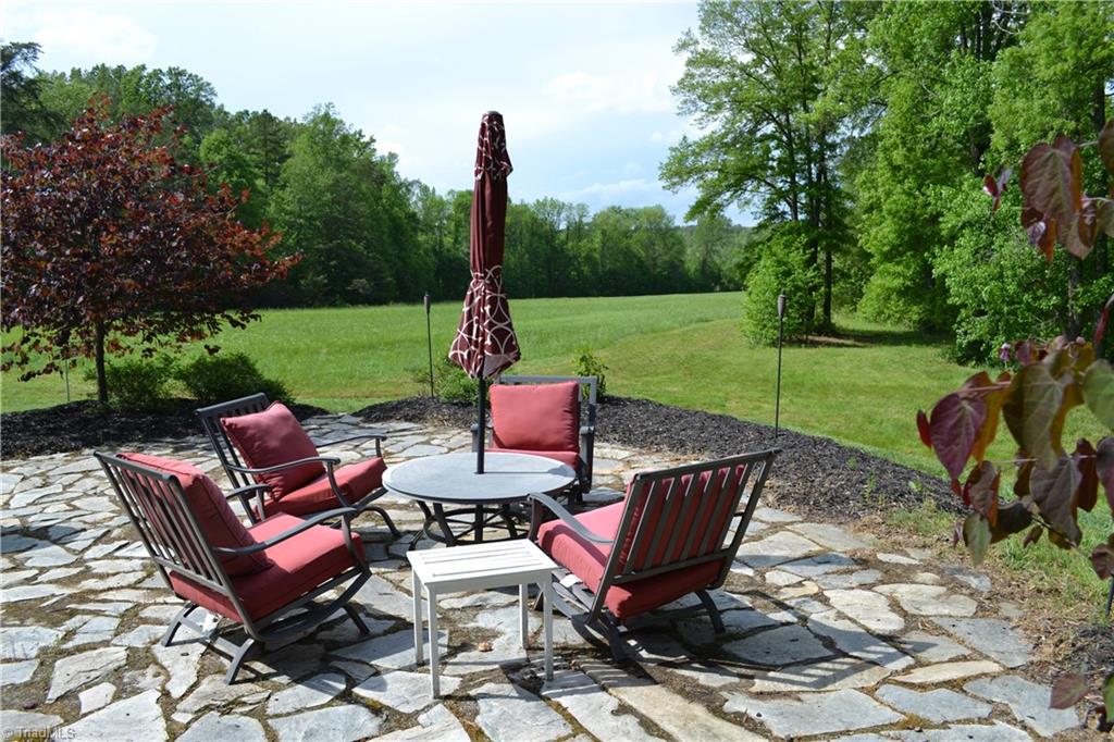 1484 Smothers Road Madison, NC 27025 - Photo 4 of 30 Back yard patio perfect for grilling or relaxing after a ride.