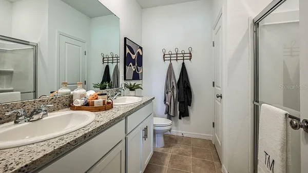 a bathroom with a double vanity sink and a mirror