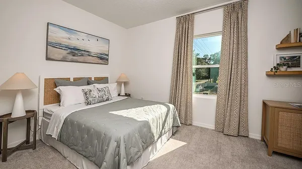 a bedroom with a bed and a painting on the wall