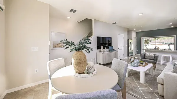a dining room with furniture a potted plant and a fireplace