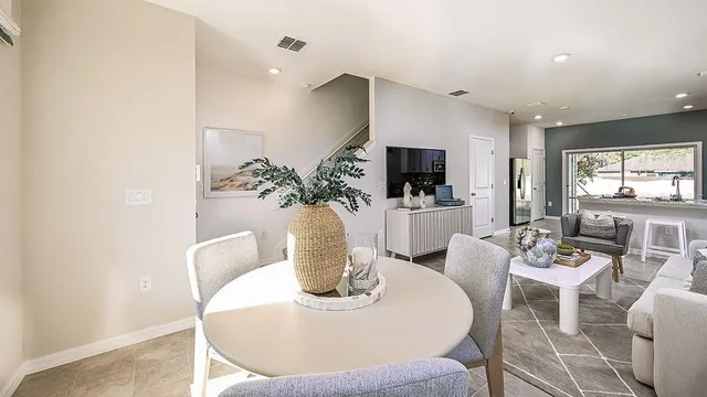 a dining room with furniture a potted plant and a fireplace