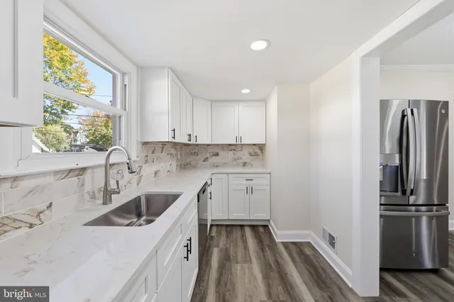 a kitchen with a sink stove and refrigerator
