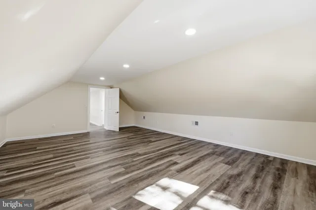 a view of an empty room and wooden floor