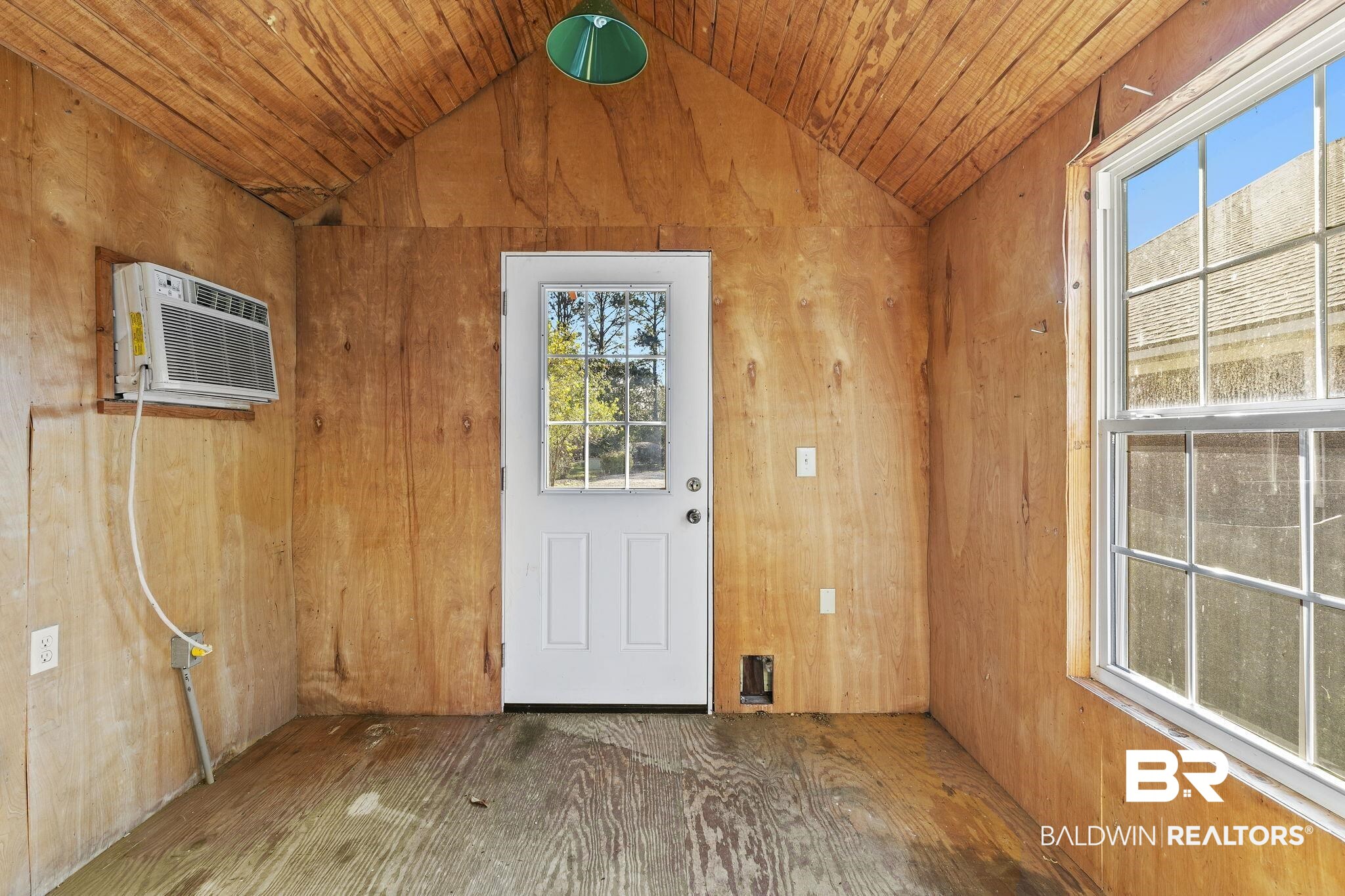 9631 Bay Meadows Avenue Fairhope, AL 36532 - Photo 32 of 49 Doorway to front of building featuring an AC wall unit.