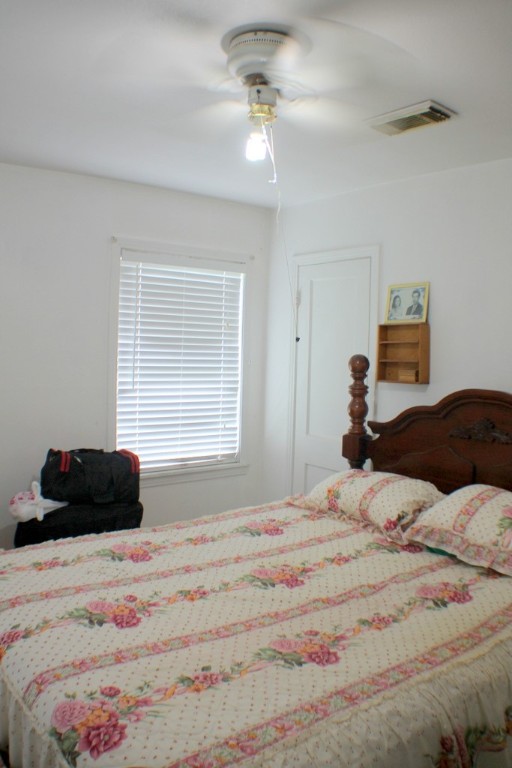 3827 Landa Lane Houston, TX 77023 - Photo 18 of 23 a bedroom with a bed a couch and a window