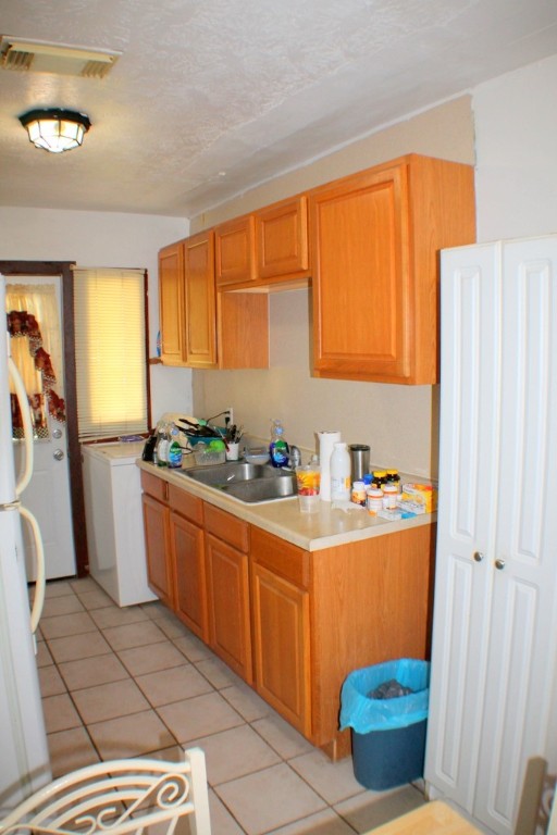 3827 Landa Lane Houston, TX 77023 - Photo 10 of 23 a kitchen with stainless steel appliances a sink and a refrigerator