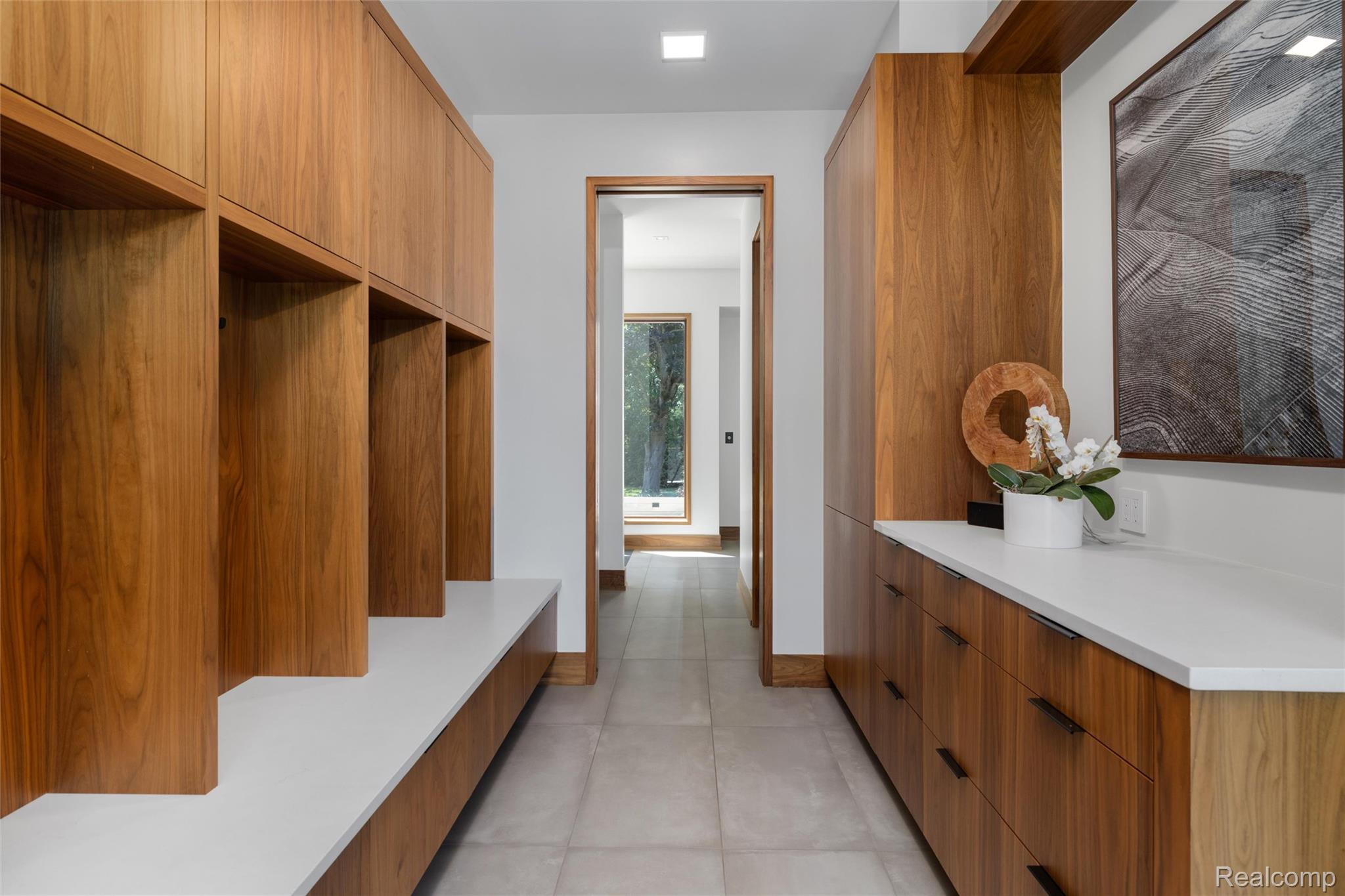 2700 Squirrel Road Bloomfield Hills, MI 48304 - Photo 22 of 83 Hallway featuring extensive wood-finish cabinetry, built-in storage cubbies, and a white countertop
