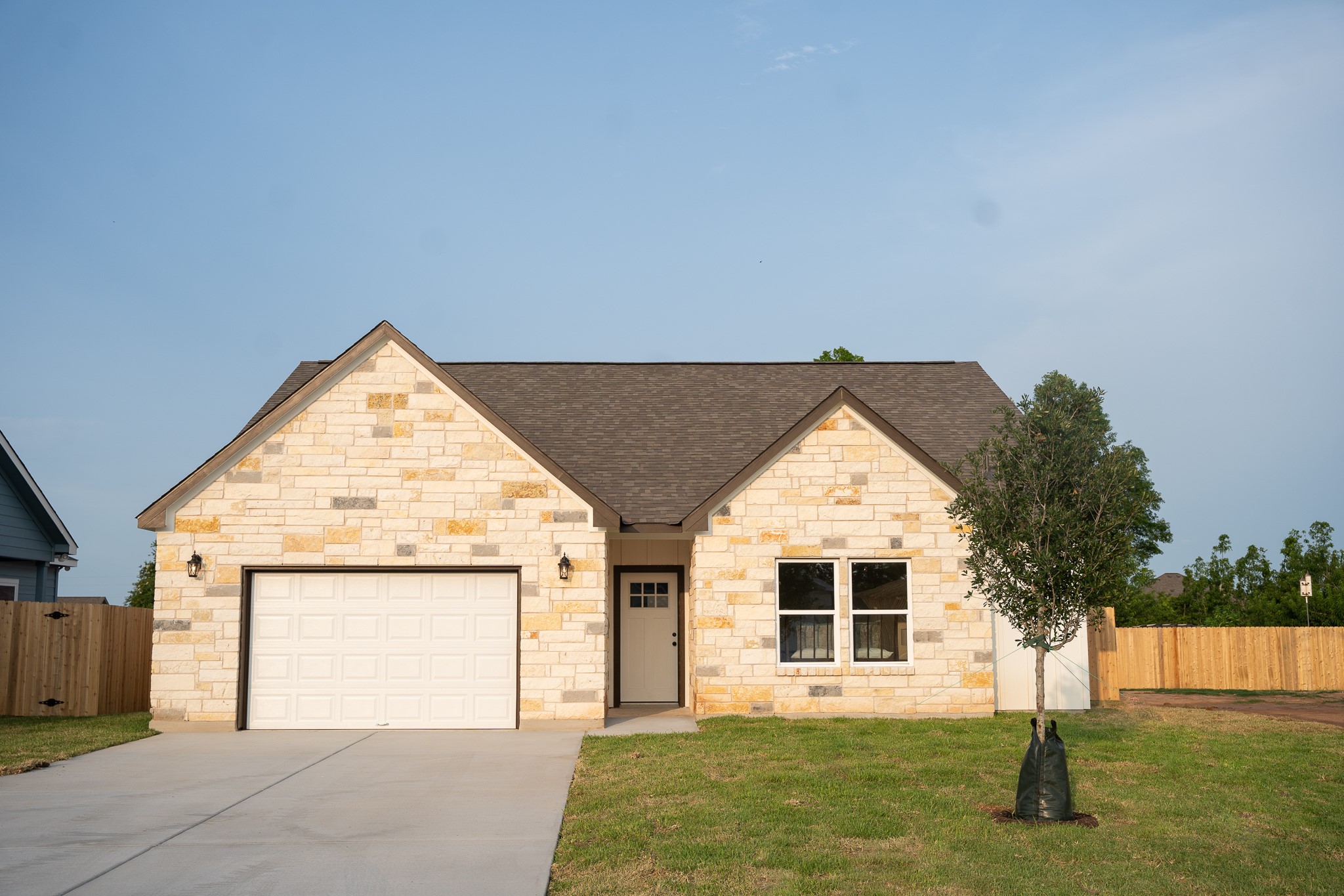 a view of a house with a yard and garage