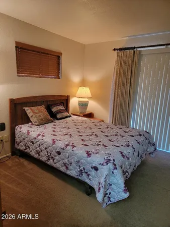 a bedroom with a bed and a night stand