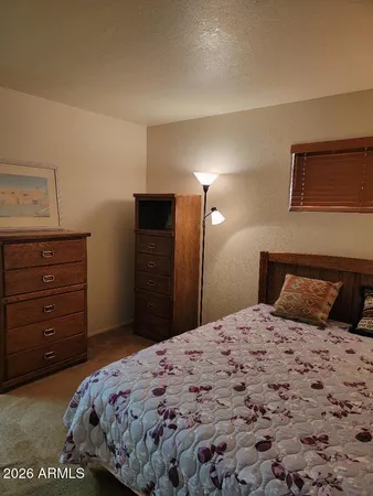 a bedroom with a bed and a mirror