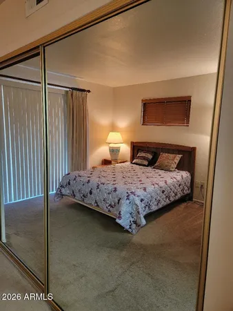 a bedroom with a bed and a night stand