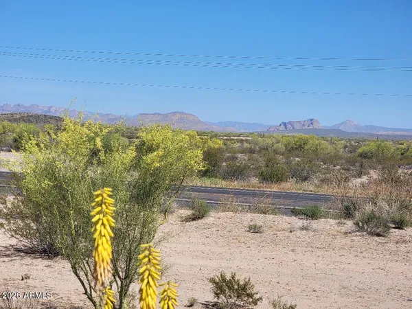 a living room with chairs and a table