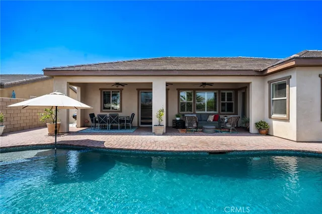 a view of a house with pool porch and chairs