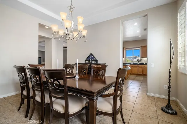 a view of a dining room with furniture and a chandelier