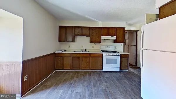a kitchen with a refrigerator and a sink