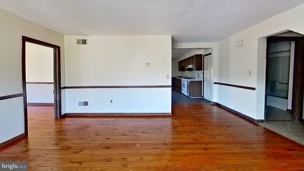 a view of a room with wooden floor