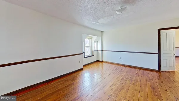 a view of a room with wooden floor