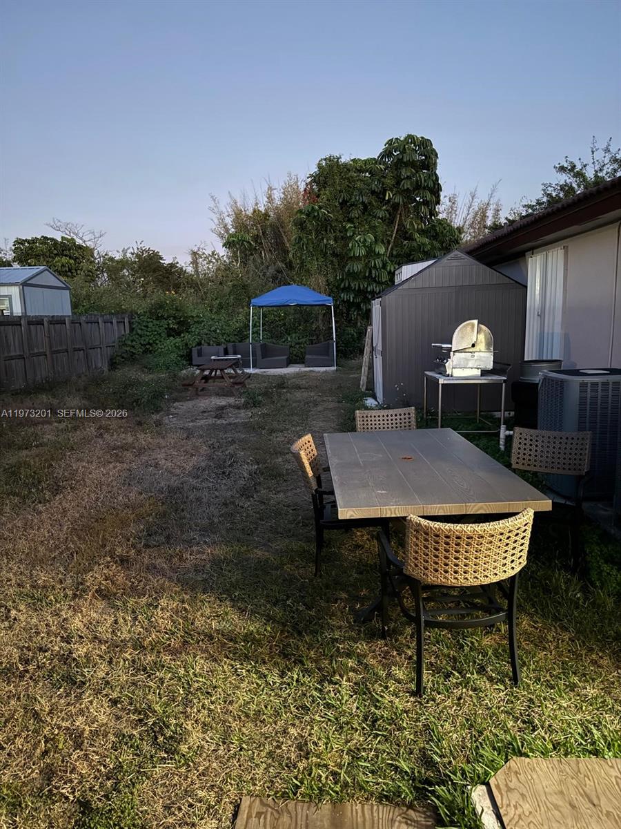 28565 Southwest 158th Court, Unit A Homestead, FL 33033 - Photo 11 of 11 a view of a chairs and table in the patio