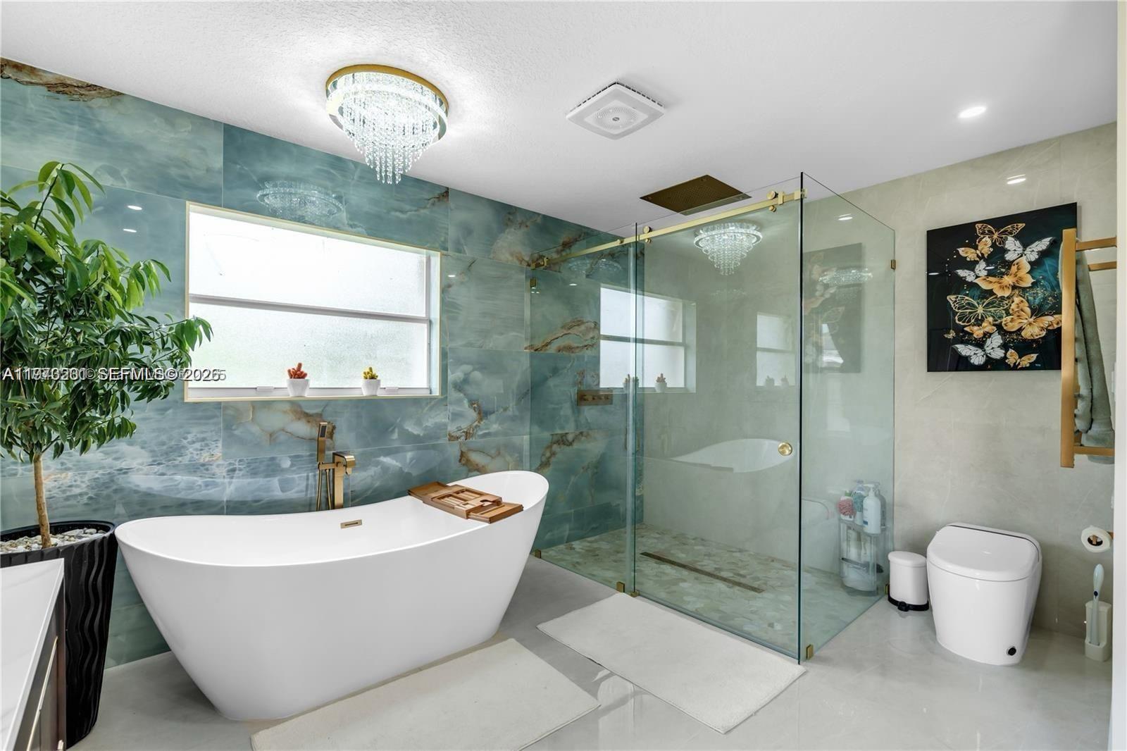 28565 Southwest 158th Court, Unit A Homestead, FL 33033 - Photo 2 of 11 a bathroom with a bathtub and a shower