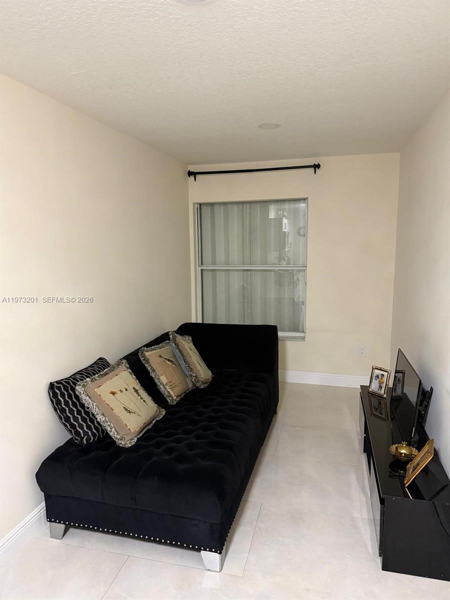 28565 Southwest 158th Court, Unit A Homestead, FL 33033 - Photo 5 of 11 a living room with furniture
