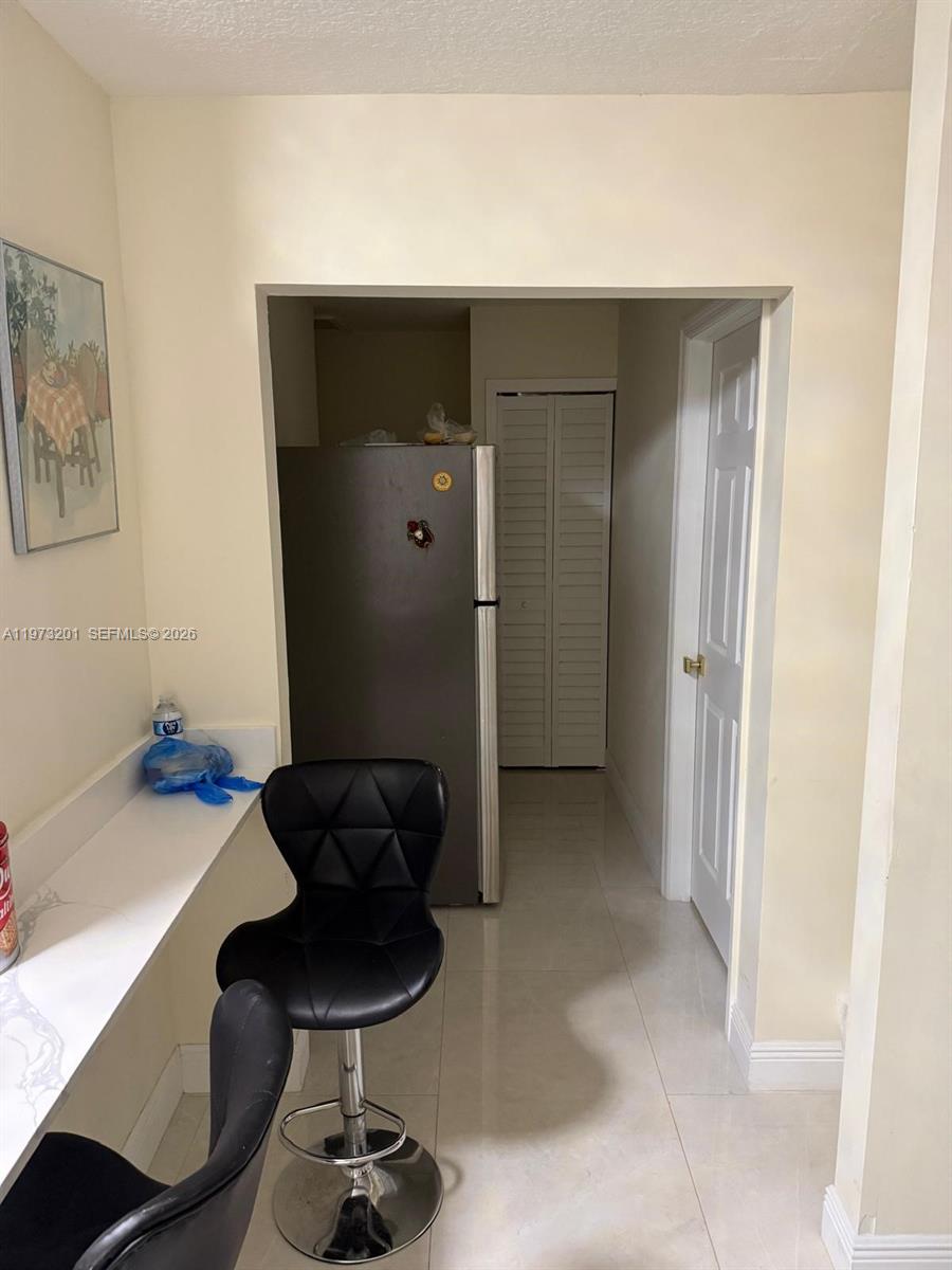 28565 Southwest 158th Court, Unit A Homestead, FL 33033 - Photo 6 of 11 a living room with furniture and a chandelier