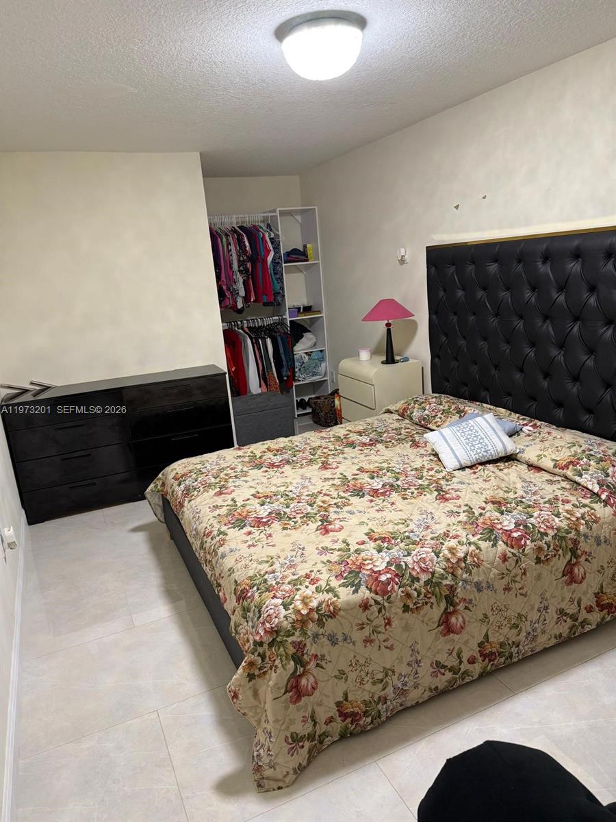 28565 Southwest 158th Court, Unit A Homestead, FL 33033 - Photo 8 of 11 a bedroom with a bed and a dresser