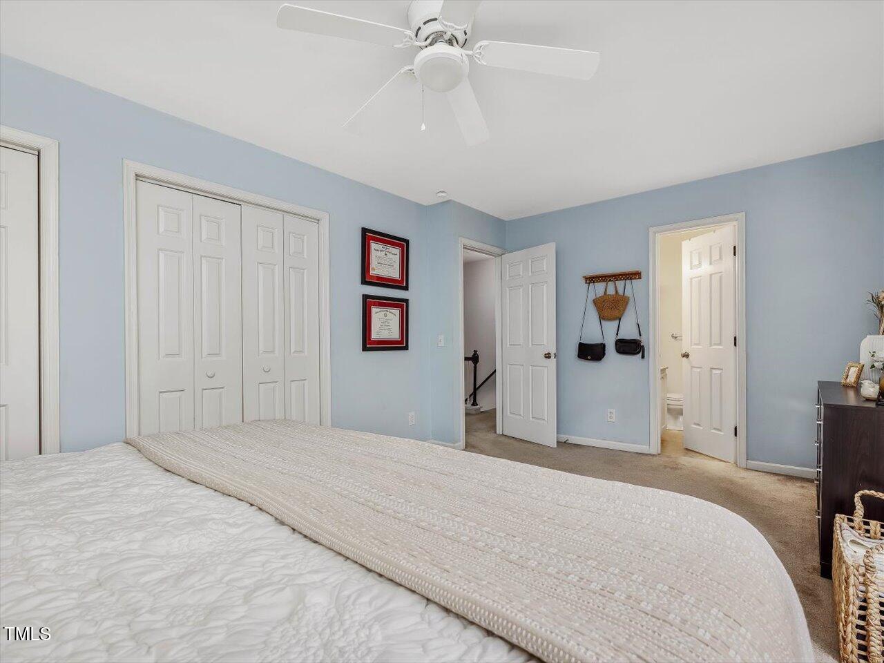 1328 Baez Street Raleigh, NC 27608 - Photo 18 of 32 a bedroom with a bed and a chandelier