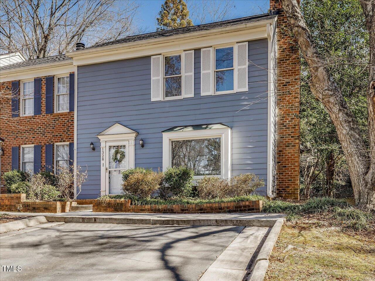 1328 Baez Street Raleigh, NC 27608 - Photo 2 of 32 front view of a brick house next to a yard