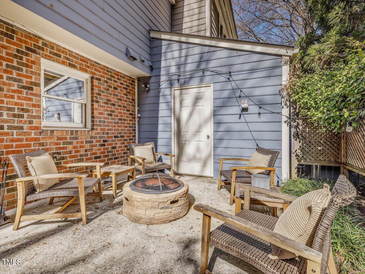 1328 Baez Street Raleigh, NC 27608 - Photo 27 of 32 a view of a patio with table and chairs and potted plants