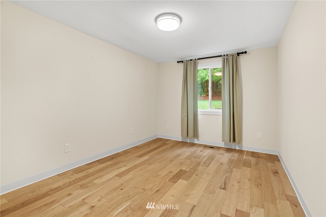 11639 Fay Road Northeast Carnation, WA 98014 - Photo 22 of 40 a view of an empty room with wooden floor and a window