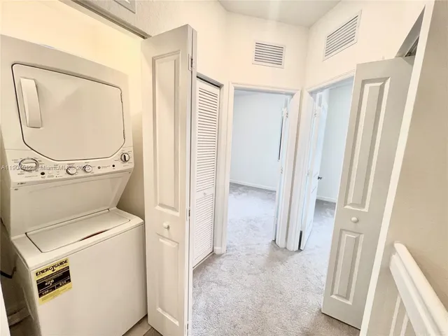 a view of a storage & utility room with a washer dryer