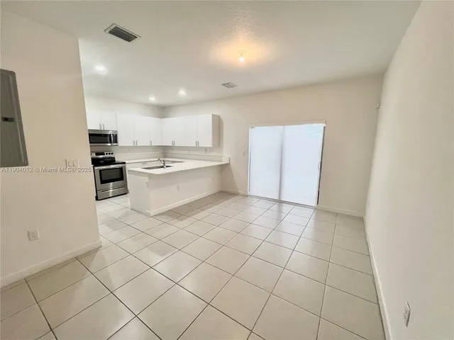 a kitchen with stainless steel appliances a sink and cabinets