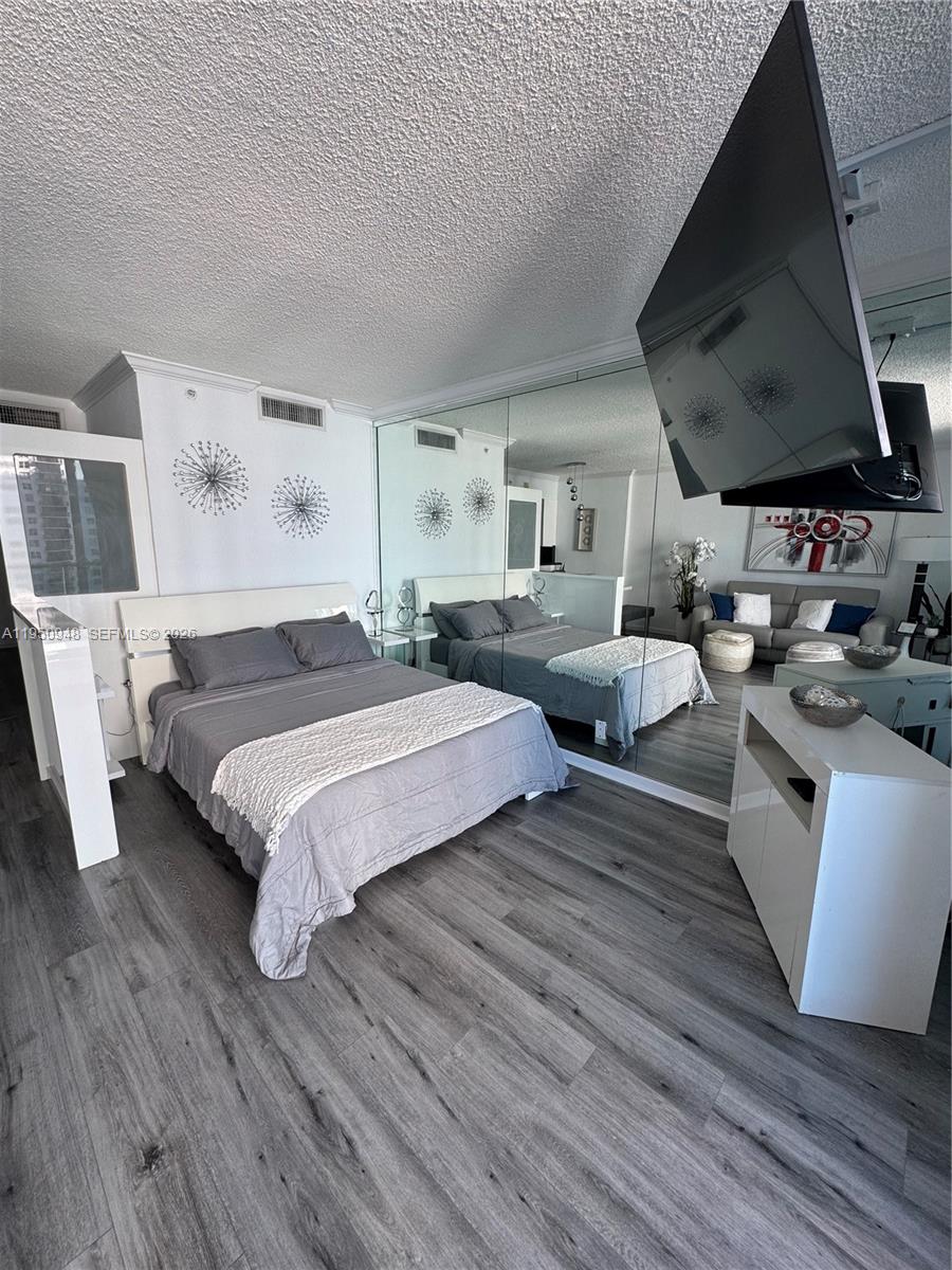 2501 South Ocean Drive, Unit 1105 Hollywood, FL 33019 - Photo 4 of 45 a spacious bedroom with a bed and wooden floor